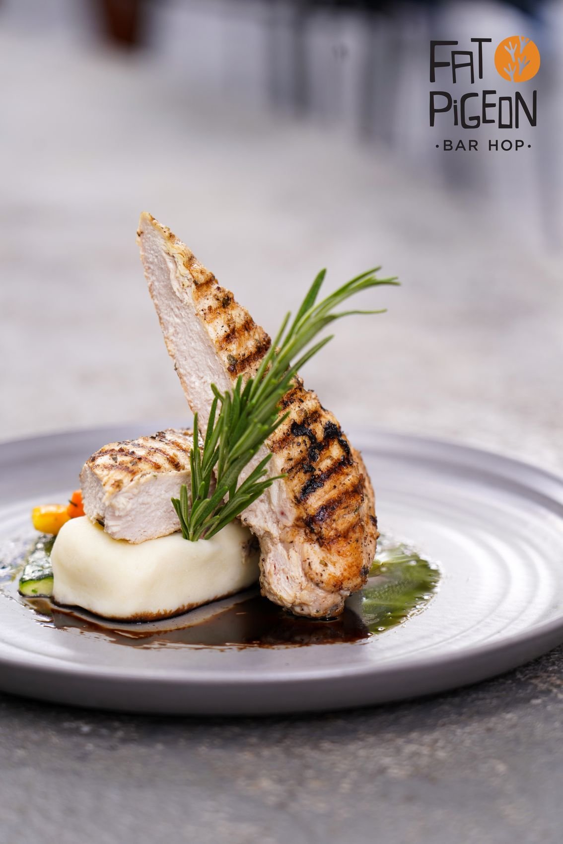 Grilled chicken with rosemary on a white plate