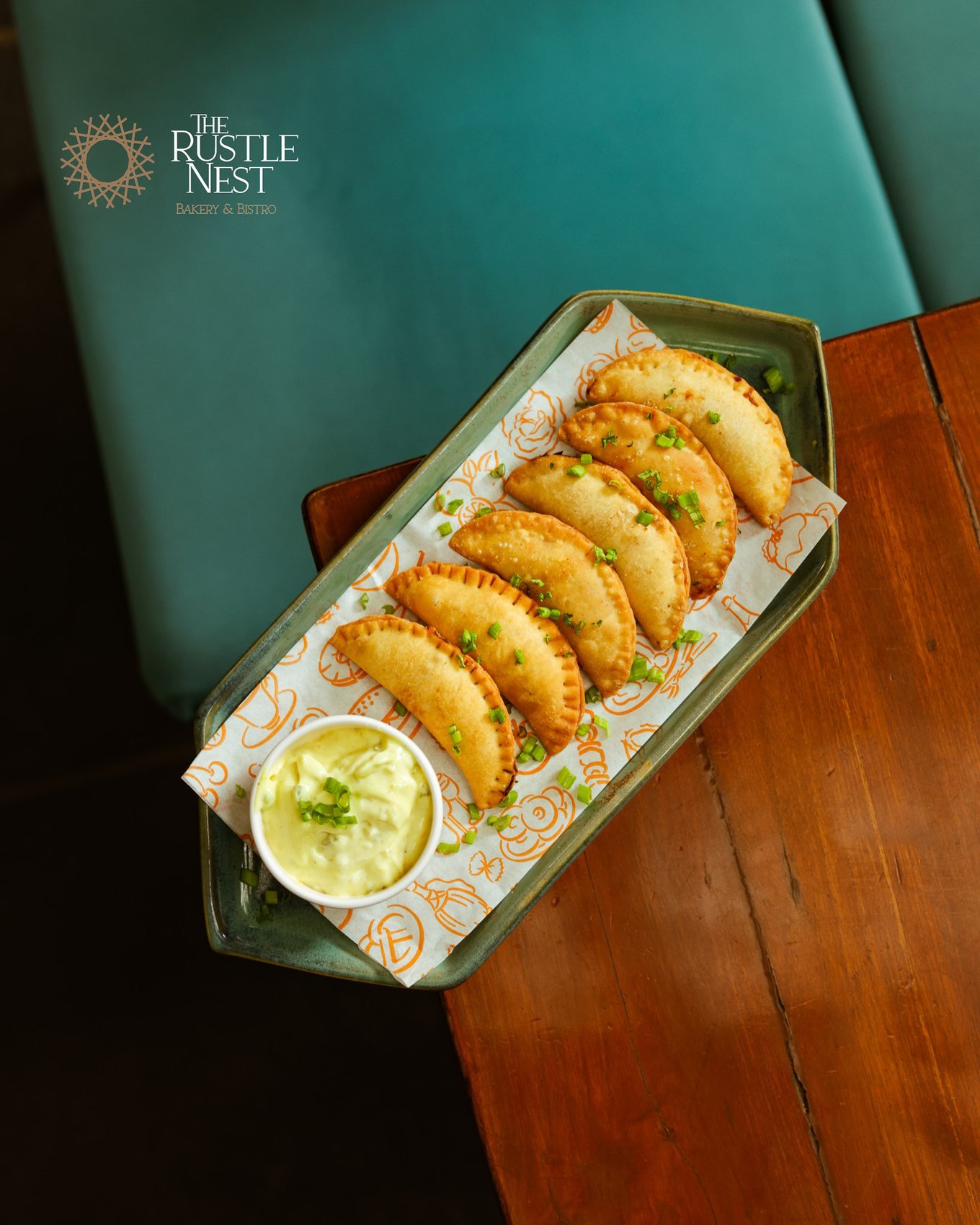 Golden fried karanji on a long plate with chutney