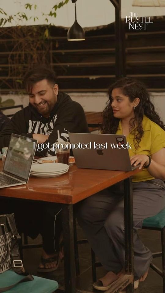 Friends working and laughing at a café table