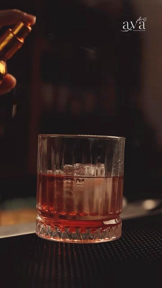 Old fashioned cocktail on a bar mat